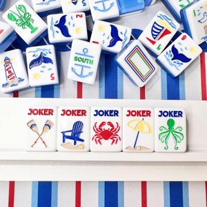 Collection of colorful game tiles with various symbols on a striped background