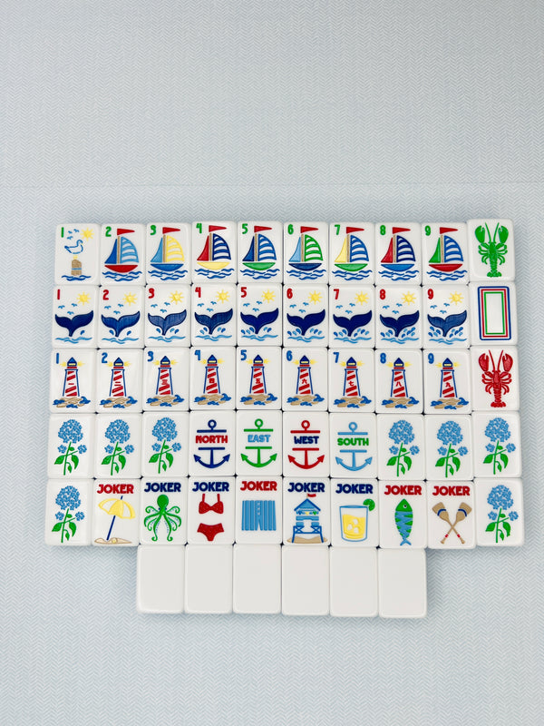 Set of colorful game tiles with various symbols on a gray background