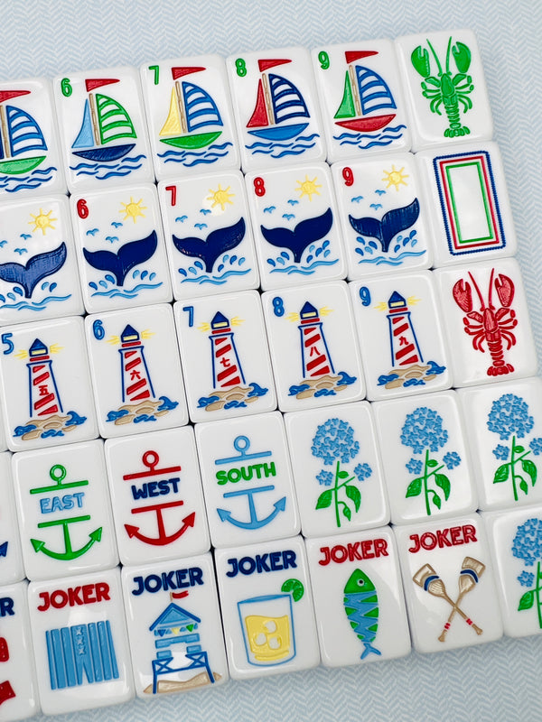 Collection of colorful mahjong tiles with various symbols on a gray background
