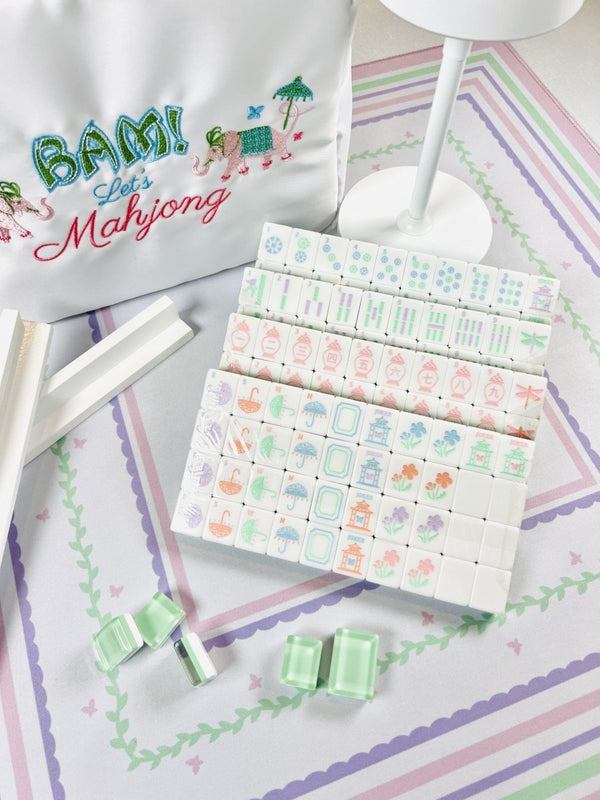 Garden party pastel mahjong tiles travel set on a display in front of a Bam! Let's Mahjong bag