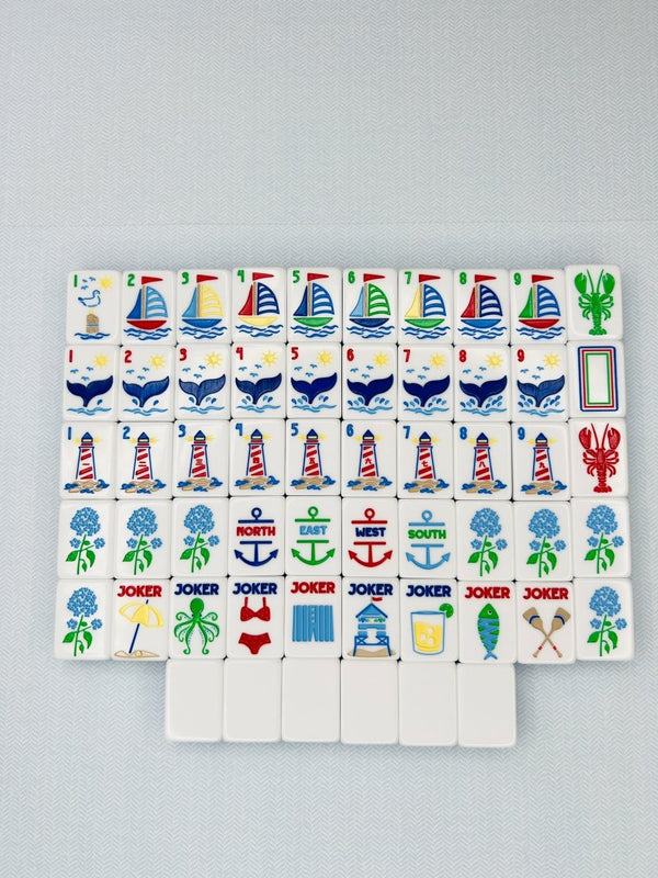 Set of colorful game tiles with various symbols on a gray background