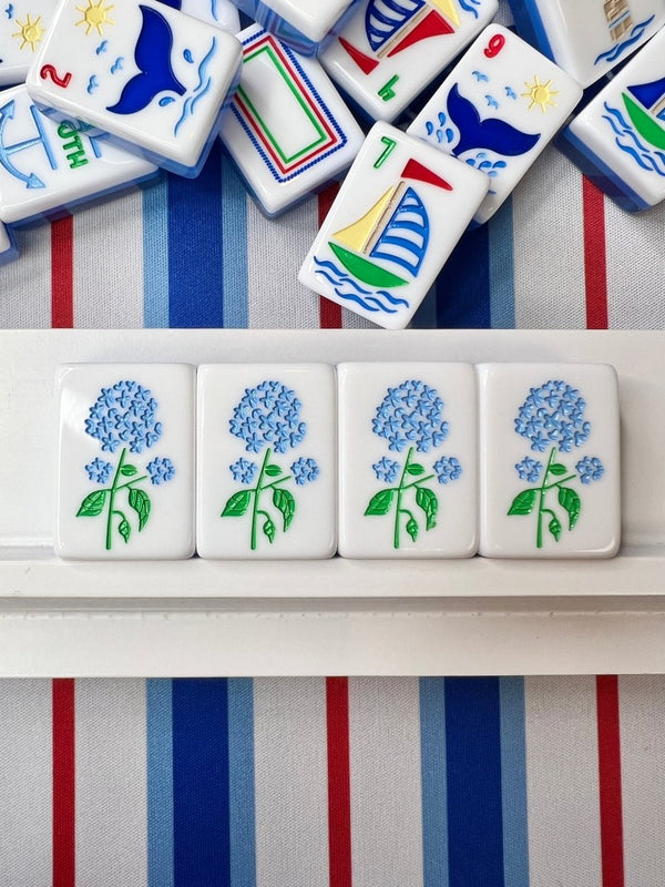 Set of decorative tiles with floral designs on a striped fabric background